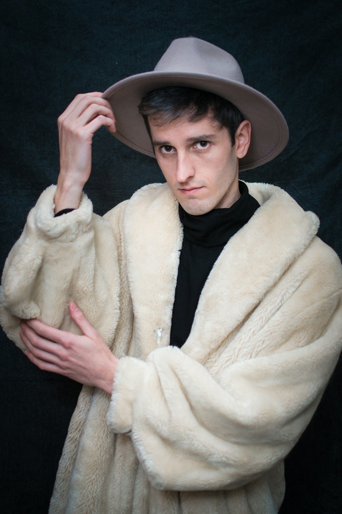 a man wearing a hat and a fur coat